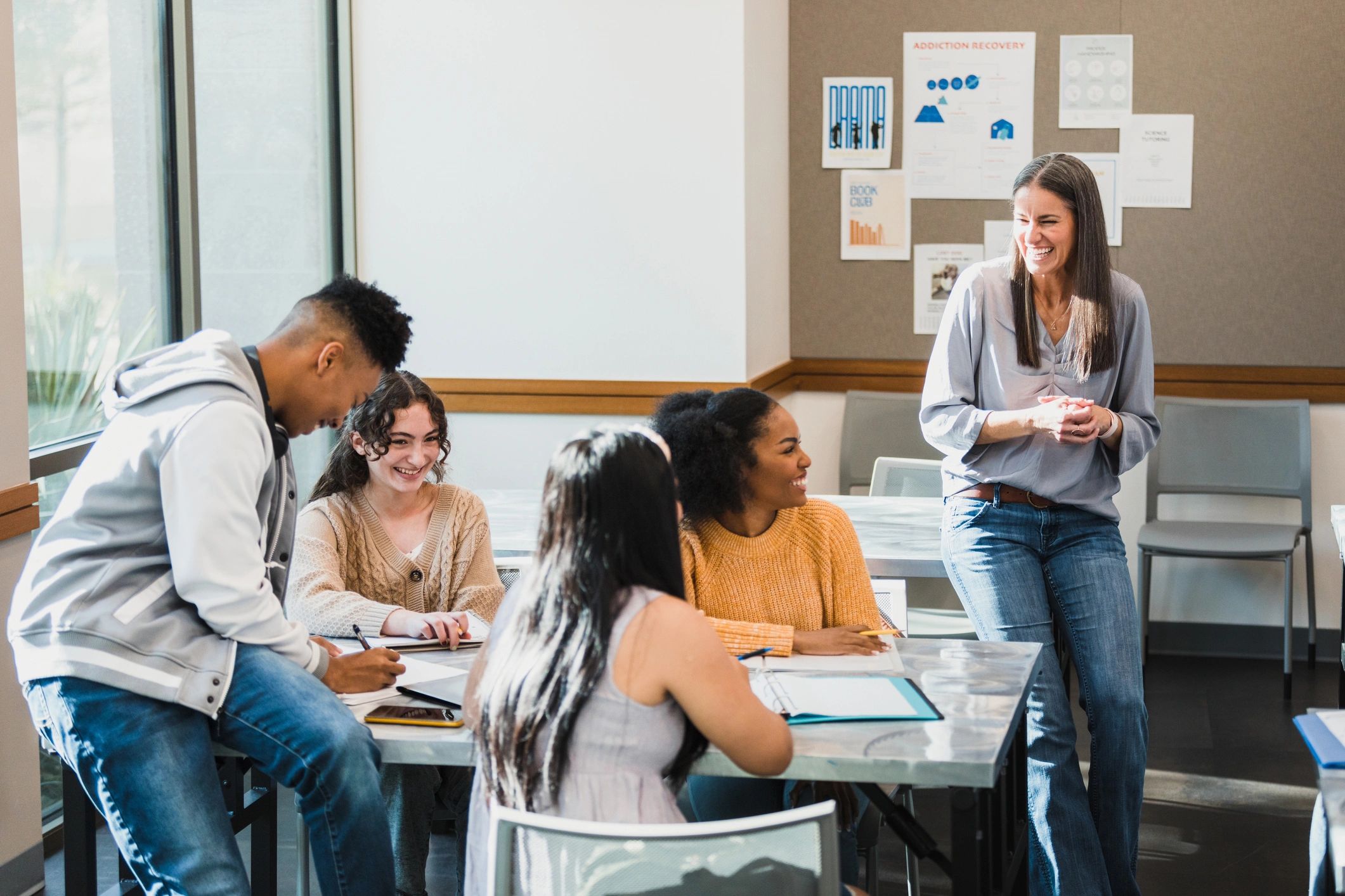 Students and a teacher collaborating in a classroom